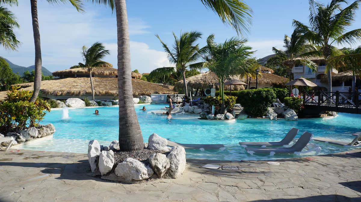 Tropical resort pool with palm trees and turquoise water
