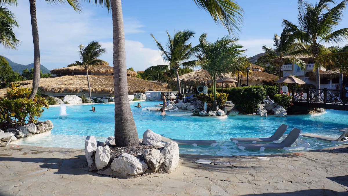 Tropical resort pool with palm trees and turquoise water